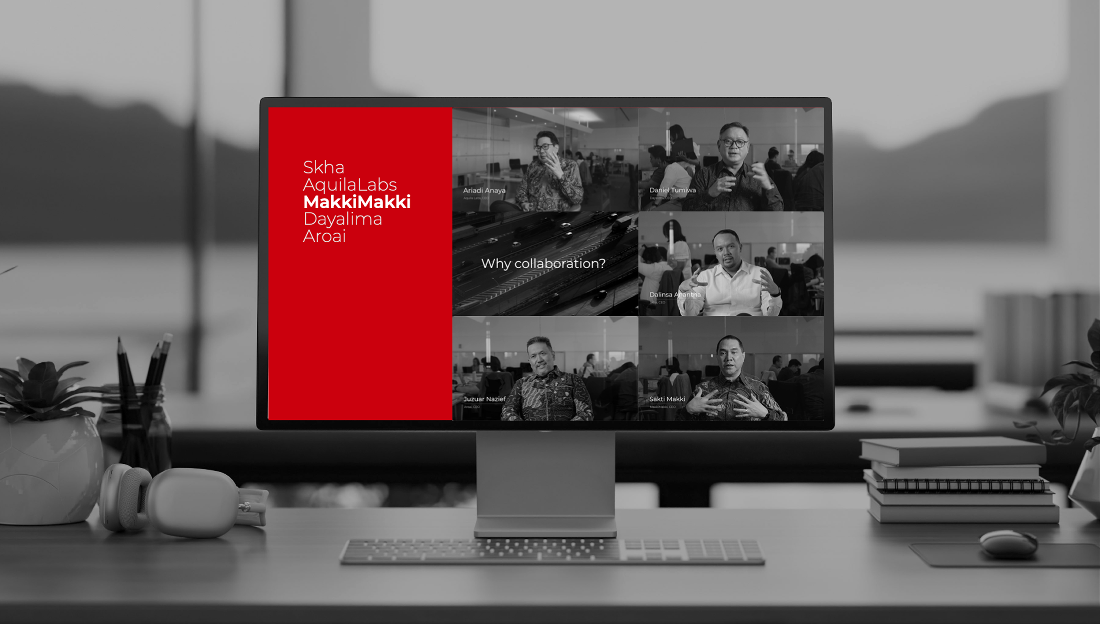 Computer monitor on desk showing a virtual meeting with six participants discussing 'Why collaboration?' Participants include Ariadi Anaya, Daniel Tumiwa, Dalinsa Anantha, Juzuar Nazief, and Sakti Makki, with a red sidebar listing 'Skha, AquilaLabs, MakkiMakki, Dayalima, Aroai'.